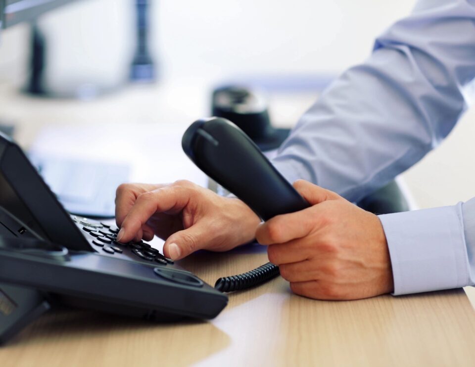 Male making a phone call in the office.